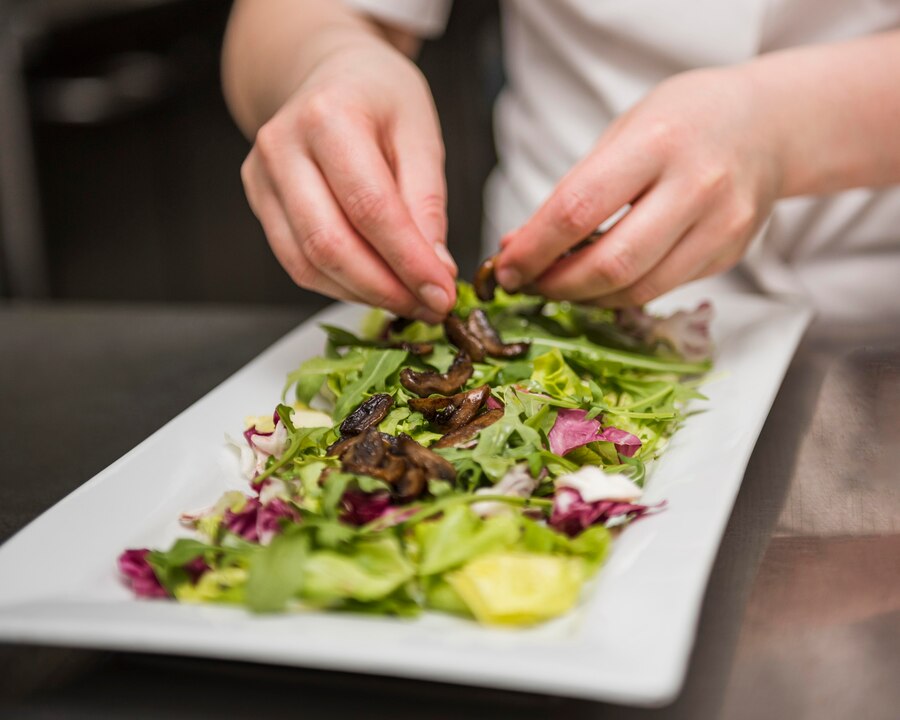 chef-placing-mushrooms-salad_23-2148516909.jpg